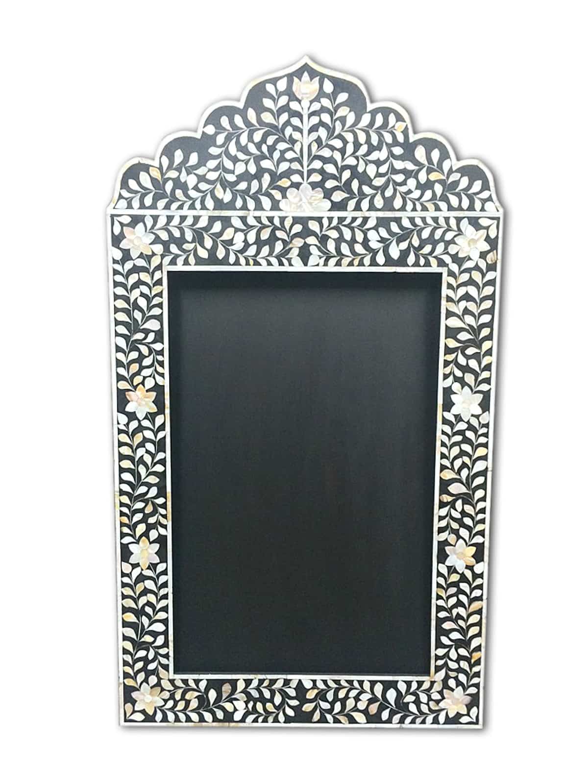 A decorative wall mirror with a floral pattern, featuring inlays of bone inlay on a black background.