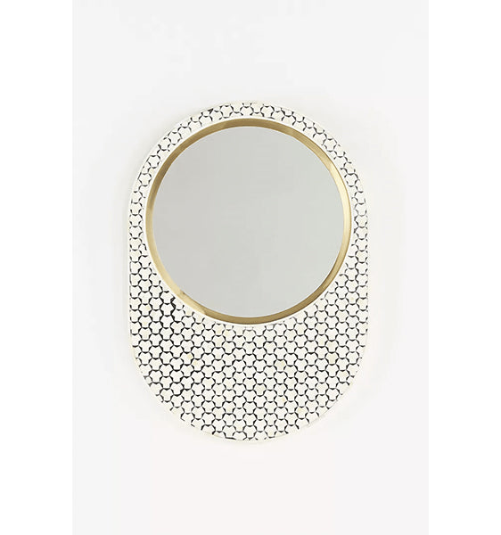 Round mirror with gold frame and black inlay pattern around the border