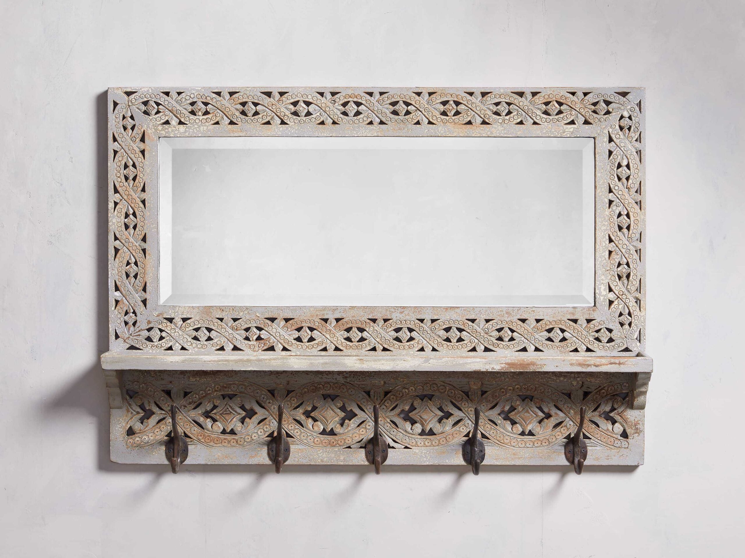 A wooden entryway bone inlay mirror with a bleached finish.