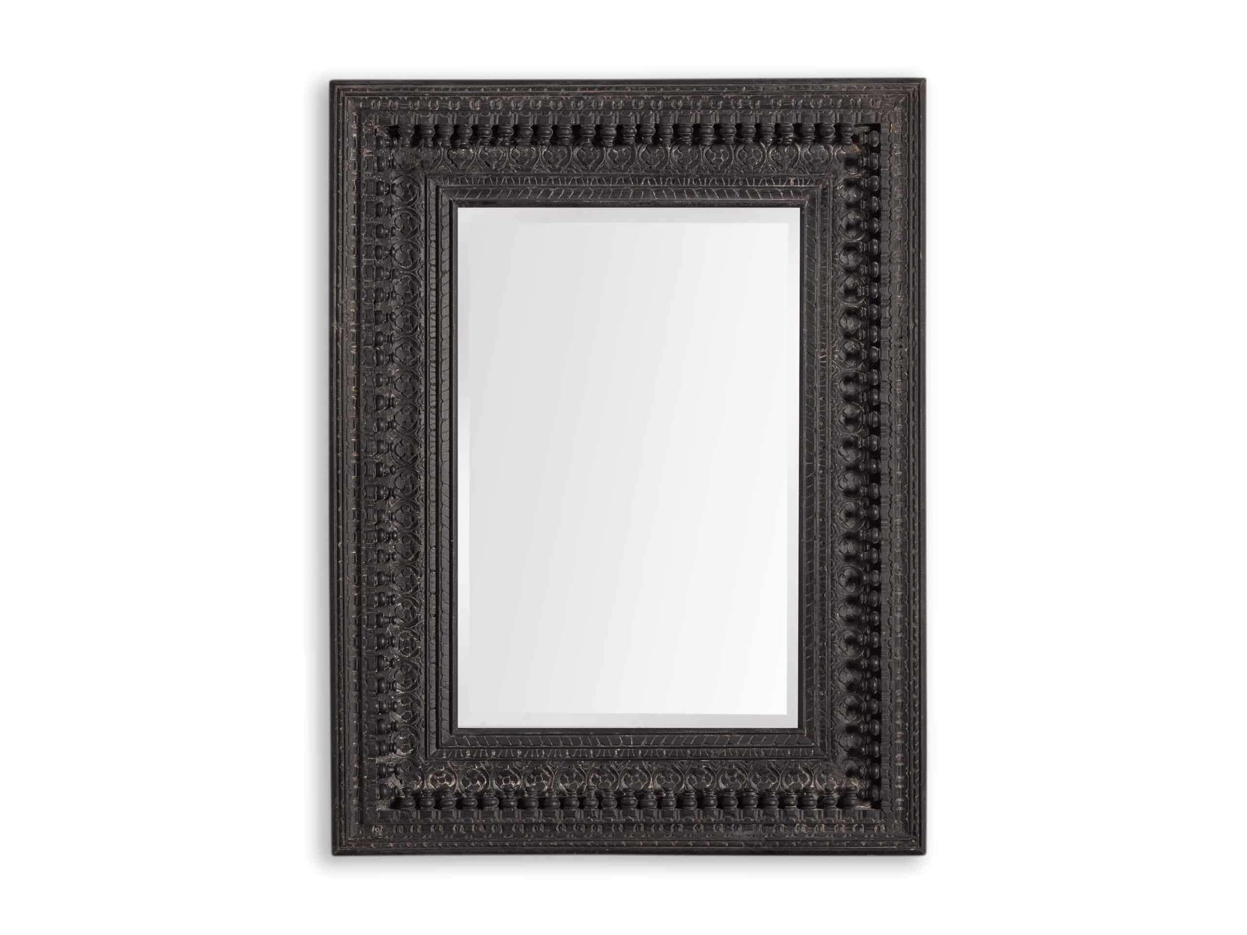 A rectangular wooden wall mirror with a mirrored center and carved wooden frame.