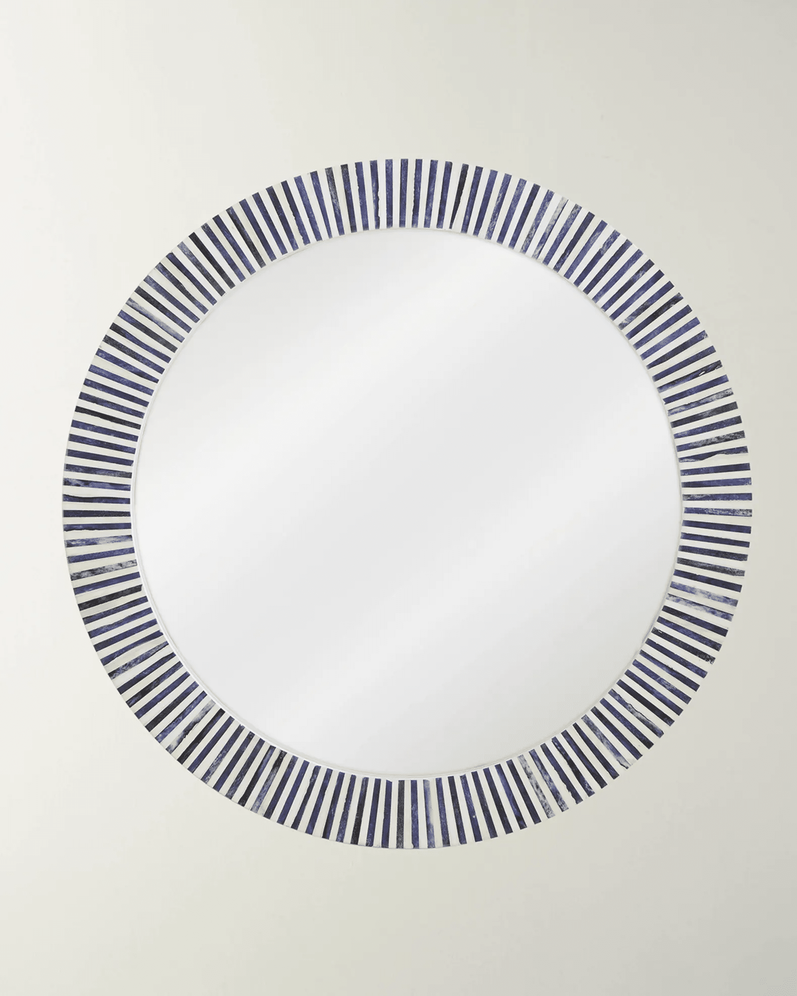 A round wall-mounted bone inlay mirror with a striped pattern