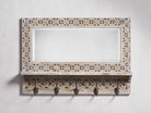 A wooden entryway bone inlay mirror with a bleached finish.