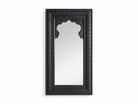A black, handcarved wooden floor mirror with a mirrored surface and ornate frame.
