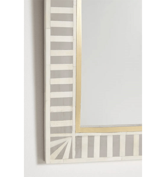 A wall-mounted bone inlay mirror with a striped bone inlay design in beige and gold tones.
